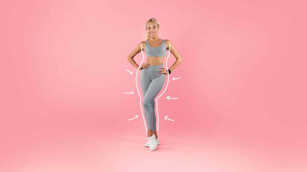 A woman in a grey sports bra and leggings, embodying a weight loss journey with Semaglutide as her solution.