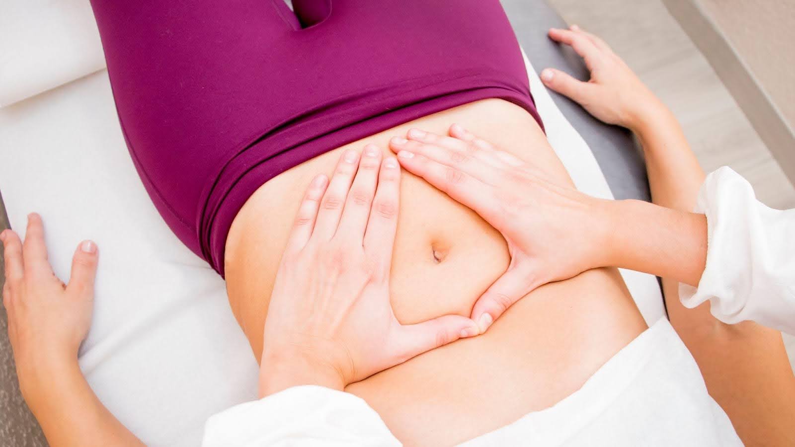 A woman is positioned on her stomach enjoying a relaxing massage from a professional therapist