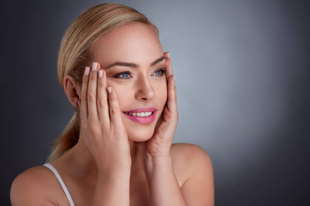 A woman with her hands on her face expressing surprise or contemplation